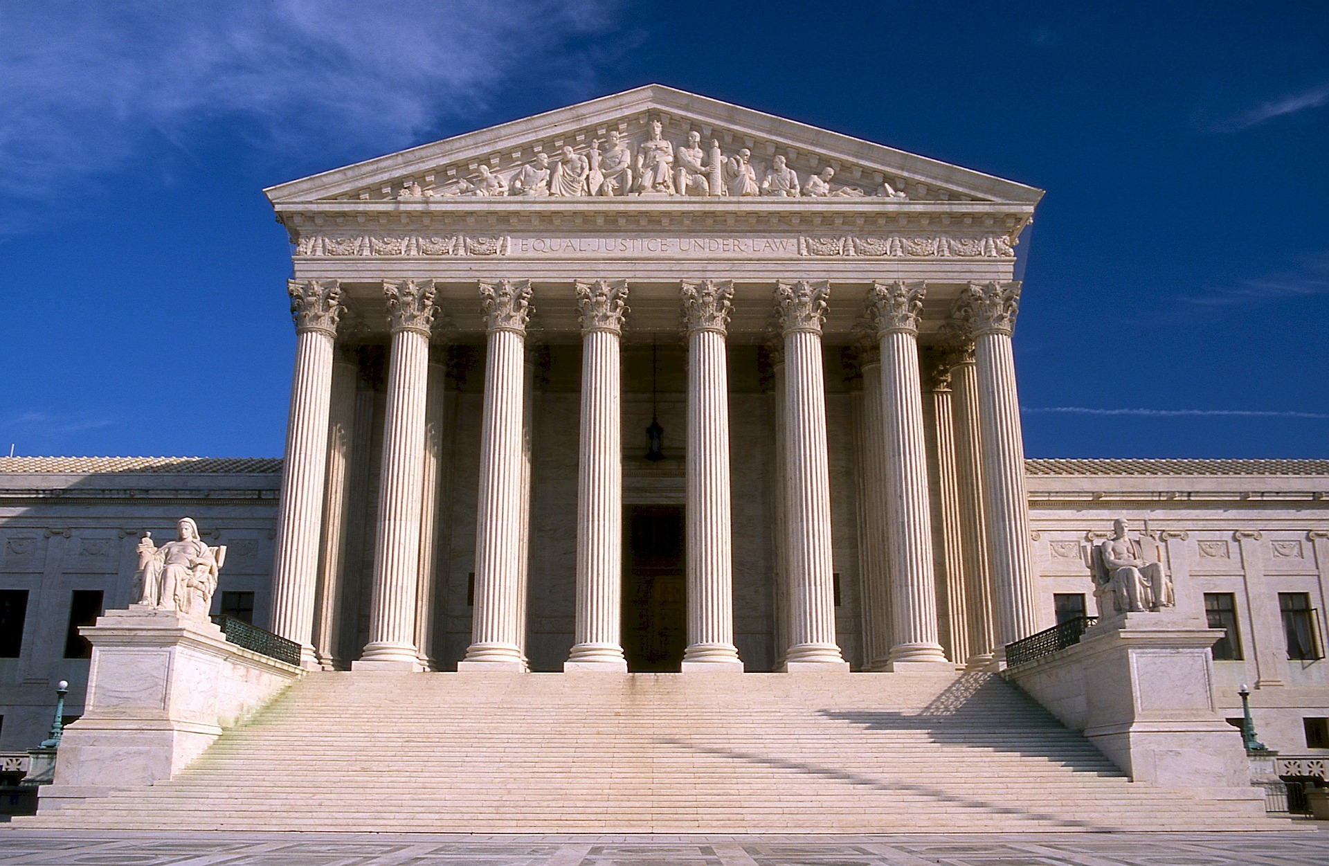 A view of the pillared front of a Supreme Court building.