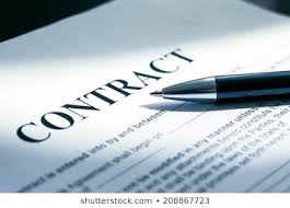 A contract with a pen lying across it.