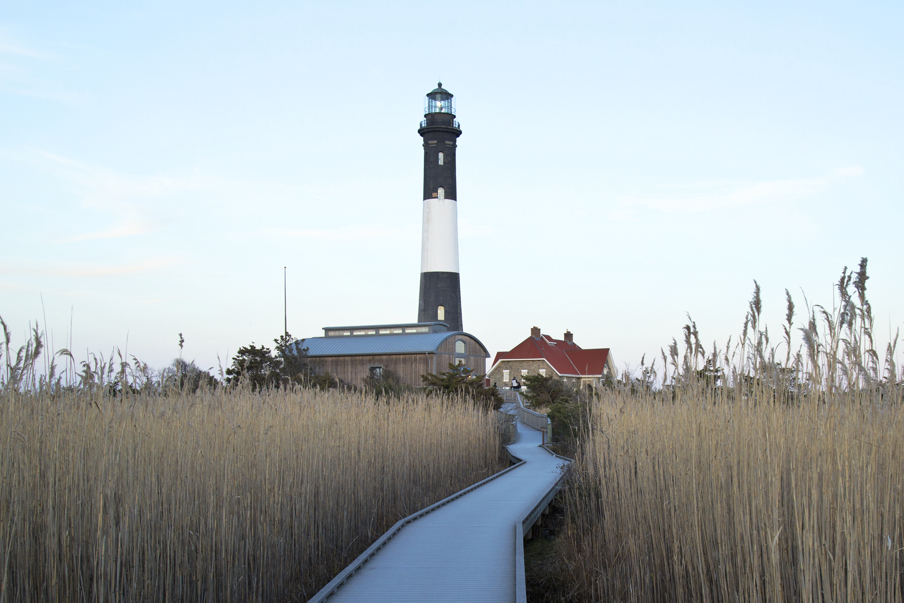 A lighthouse on Long Island, with a walkway leading to it.